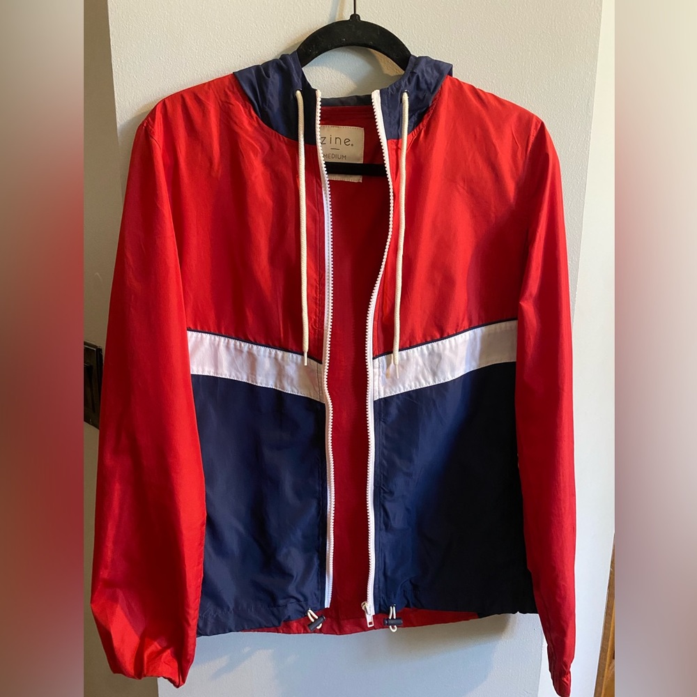 Red, dark blue, and white windbreaker jacket.